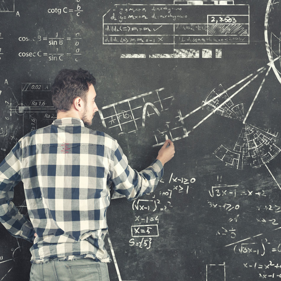 Working professionals solving physics equations on chalkboard
