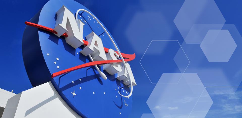 NASA logo, as part of a white building, against a blue sky.