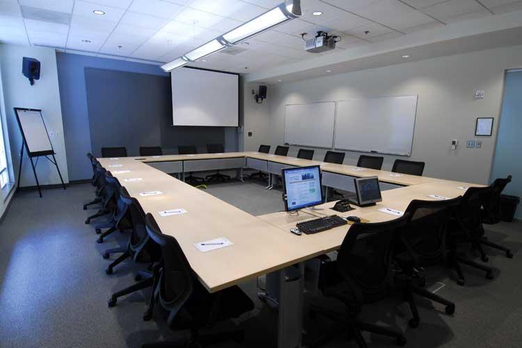 View of computer monitors and projection screens in the conference room