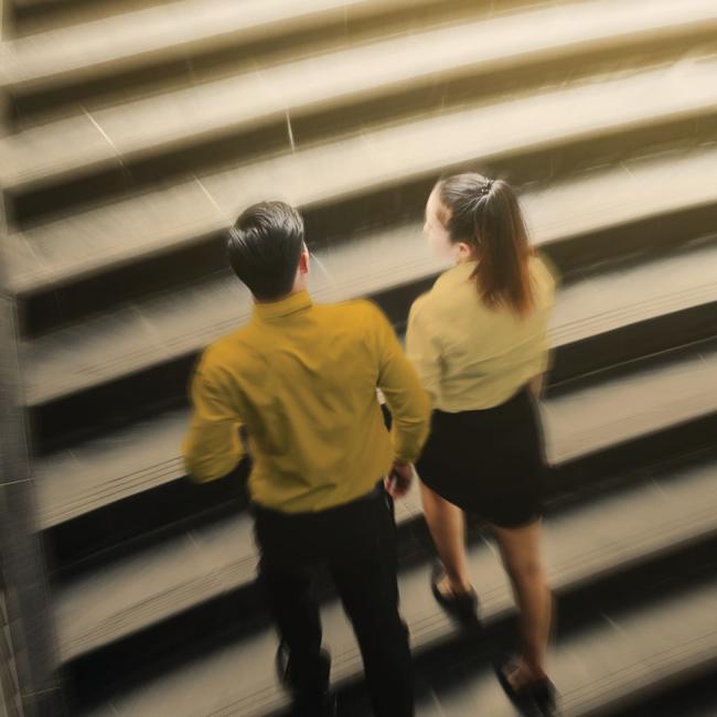 Man and woman walking up stairs